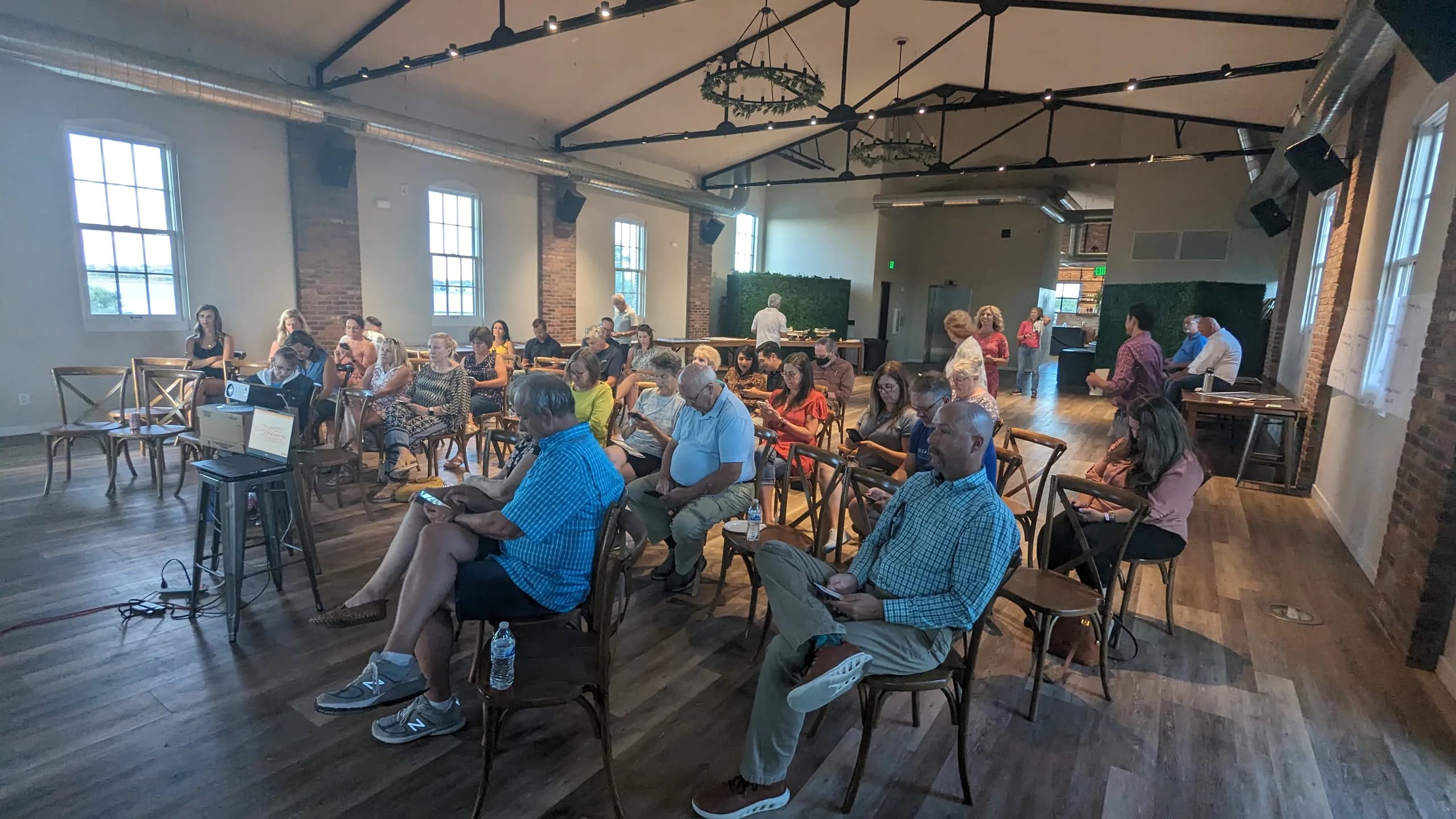 A full room of Windsor residents at a downtown planning workshop in a brick hall